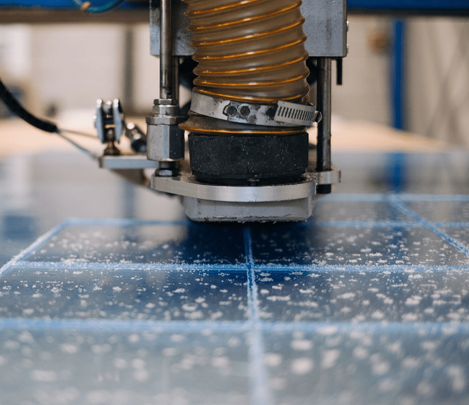 Detailed view of a plastic milling machine creating intricate designs