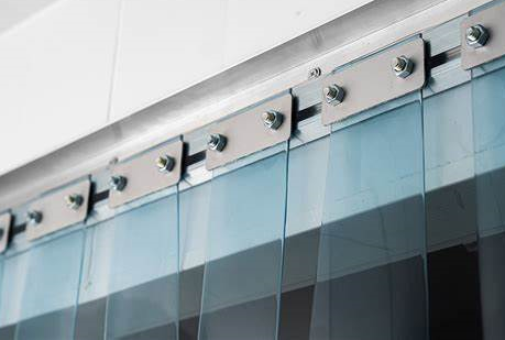 Close-up of PVC strip curtains being installed with precision